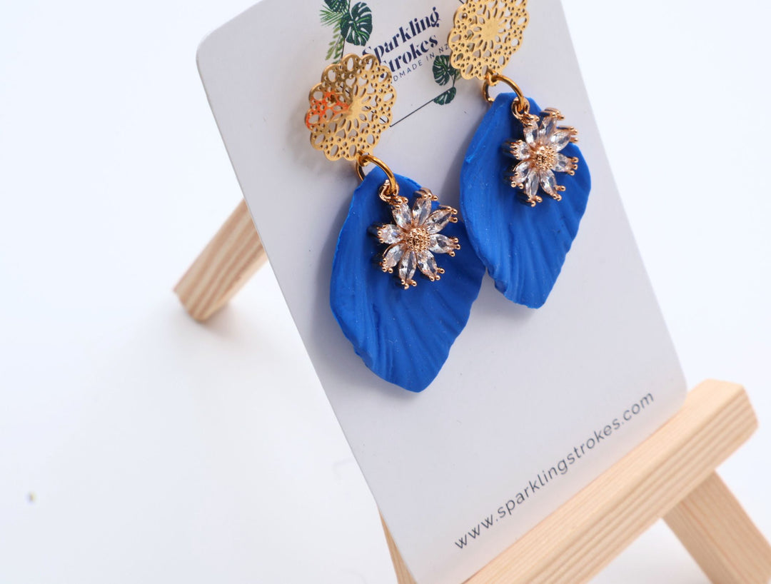Blue Floral Dangle Earrings with Charm – Elegant & Feminine